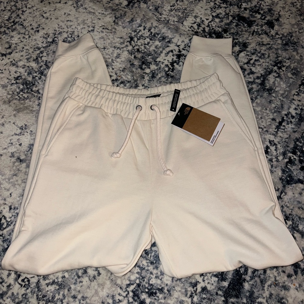 The Northface women’s size medium cream colored jogger sweats
